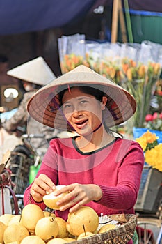 Woman selling fruits in a street market of HoÃÂ n KiÃ¡ÂºÂ¿m, the old quarter of Hanoi